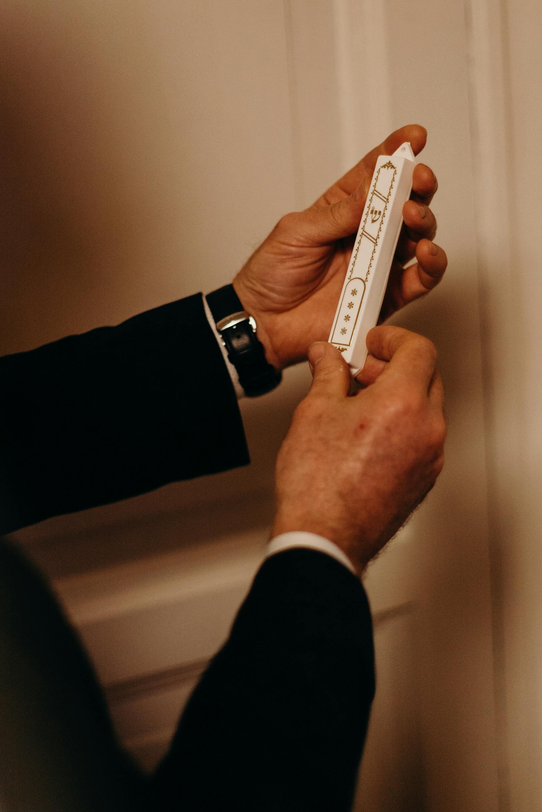 A mezuzah scroll opened at home by a certified sofer